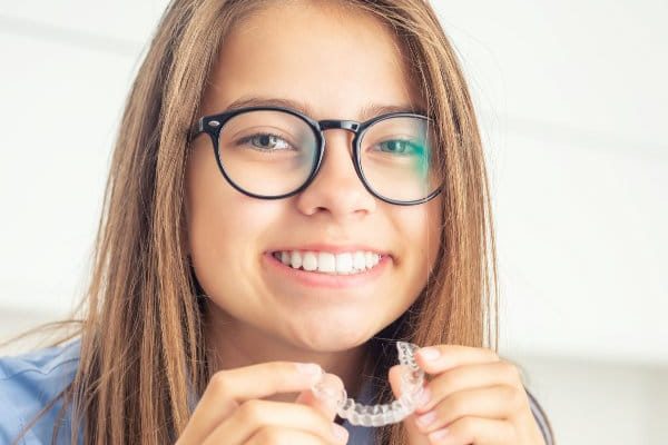 Young girl with dental invisible braces.